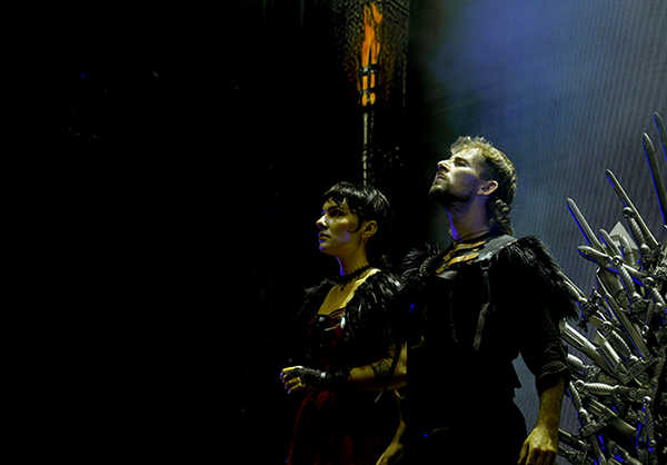 Actors under a spotlight with swords